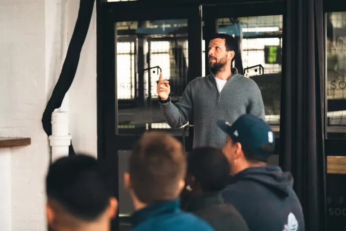 A man explains tactics to team members