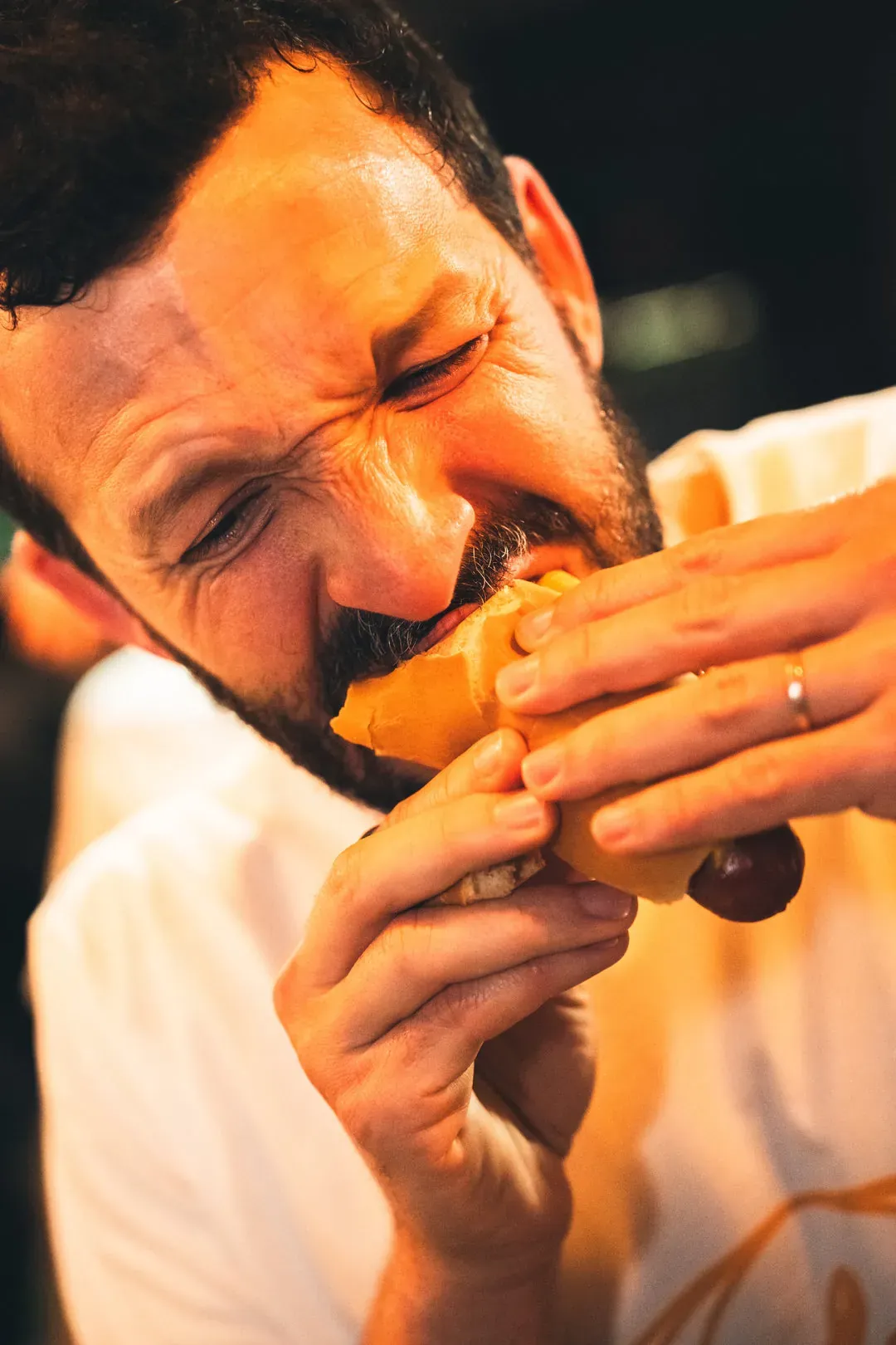 A man eats a hot dog with appetite
