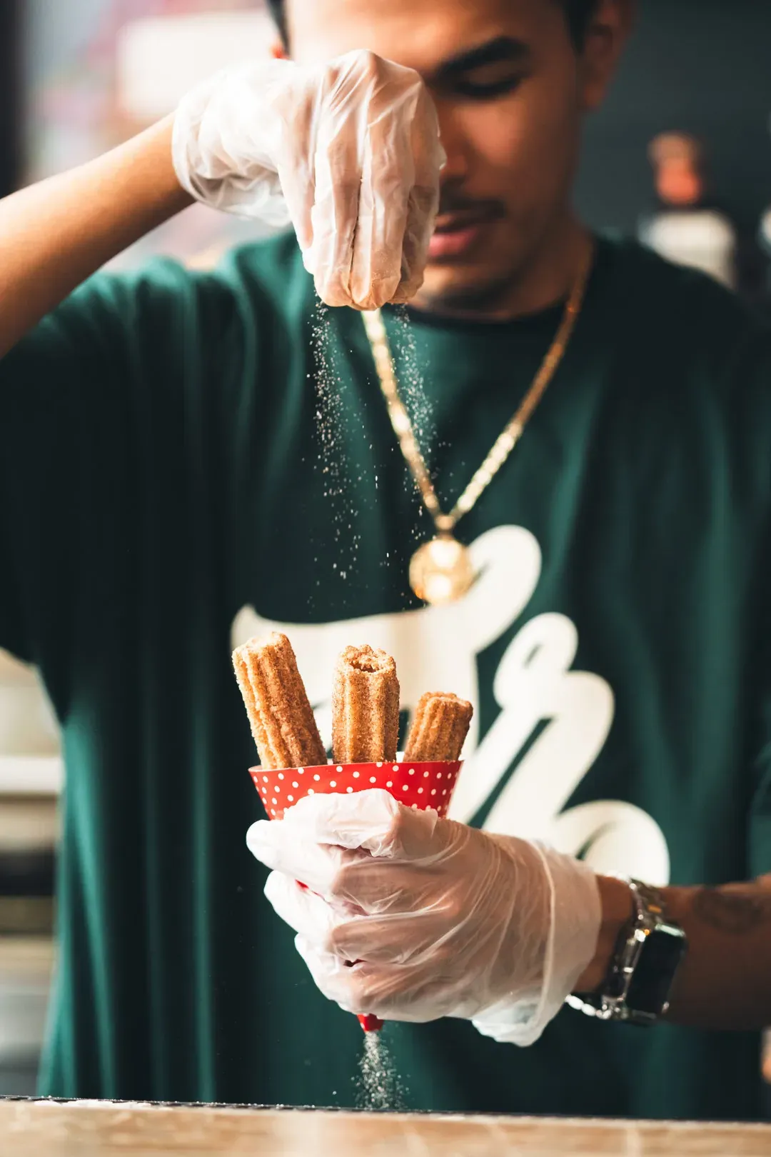 A man seasons delicious waffles